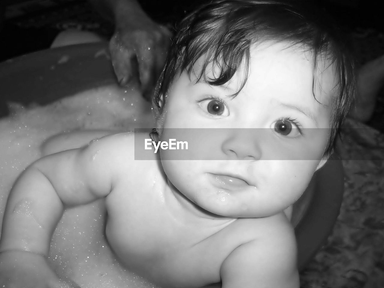 High angle portrait of baby girl sitting in bathtub