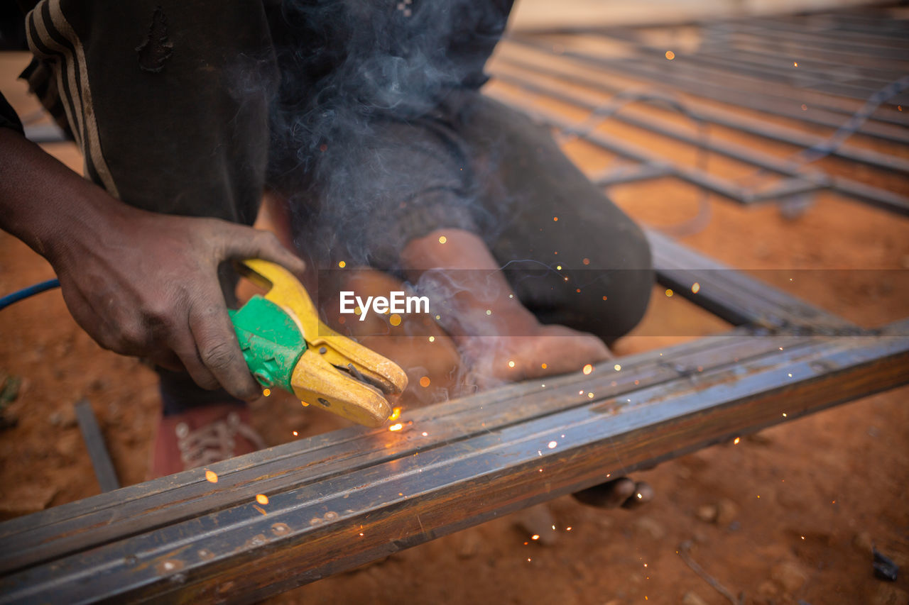 Zambian welder, welding , african man working with his hands 