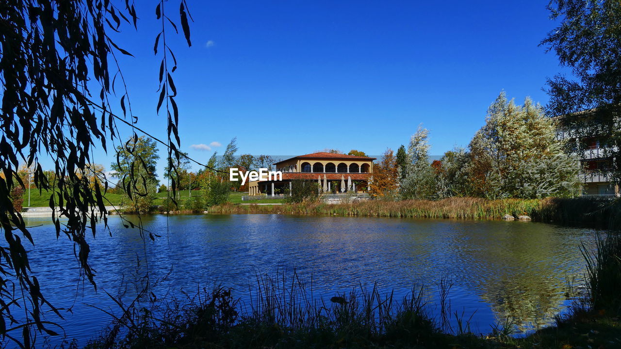 SCENIC VIEW OF LAKE AGAINST BUILDINGS