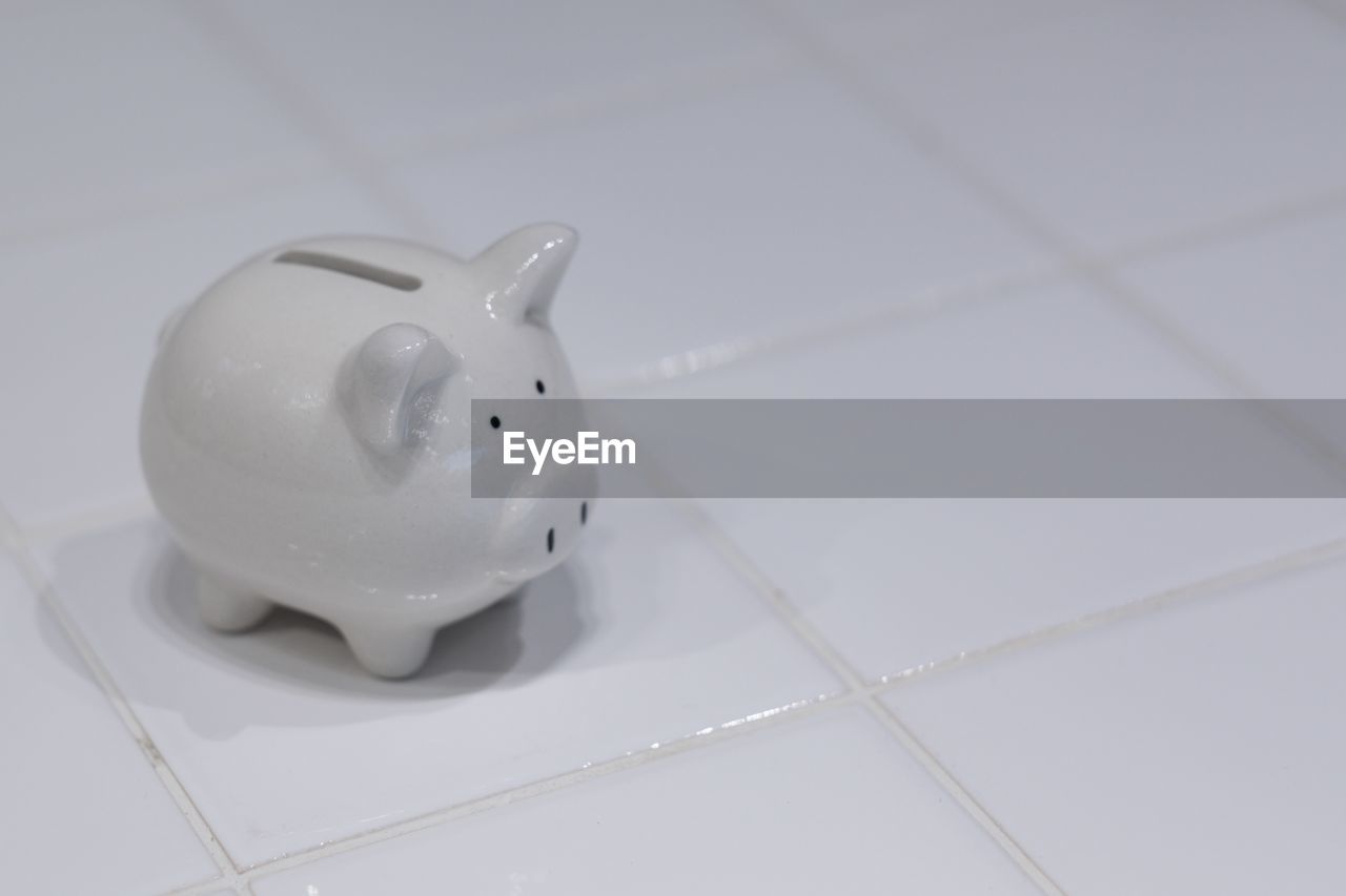 High angle view of piggy bank on floor