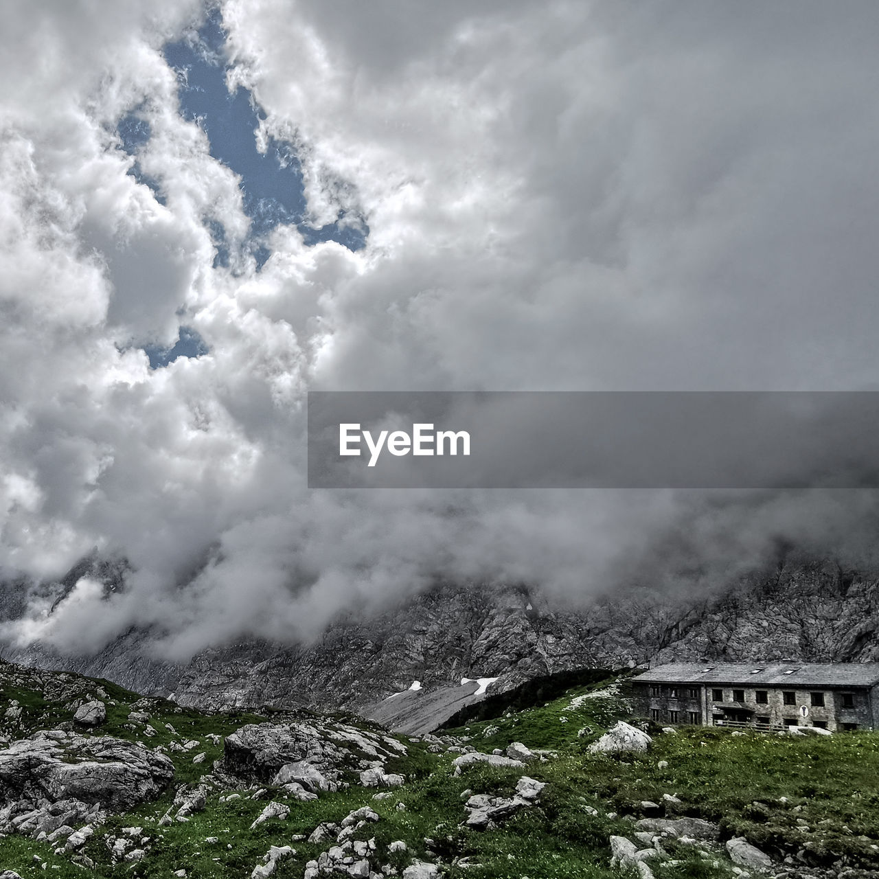 SCENIC VIEW OF MOUNTAINS AGAINST CLOUDY SKY