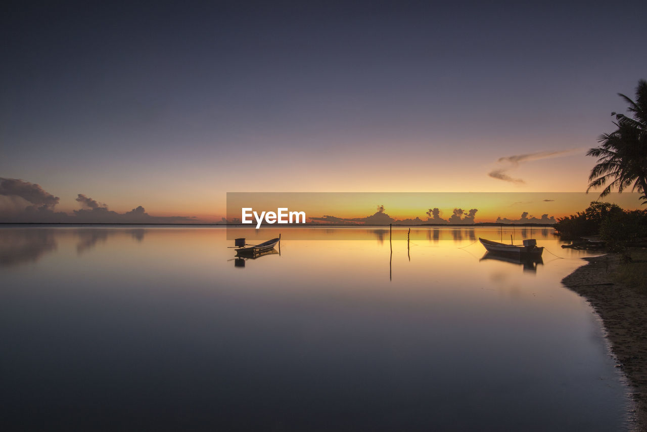 Scenic view of lake against sky during sunset