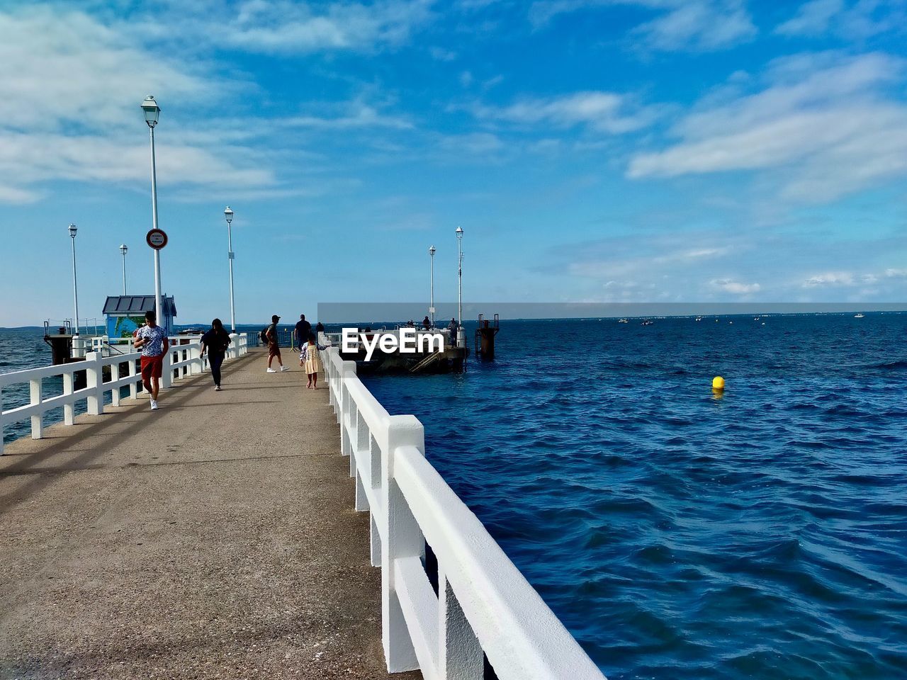 PIER ON SEA AGAINST BLUE SKY
