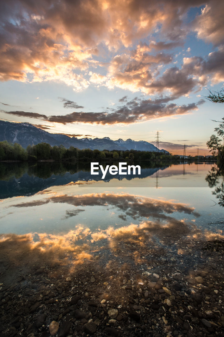 Scenic view of lake reflecting the sky during sunset