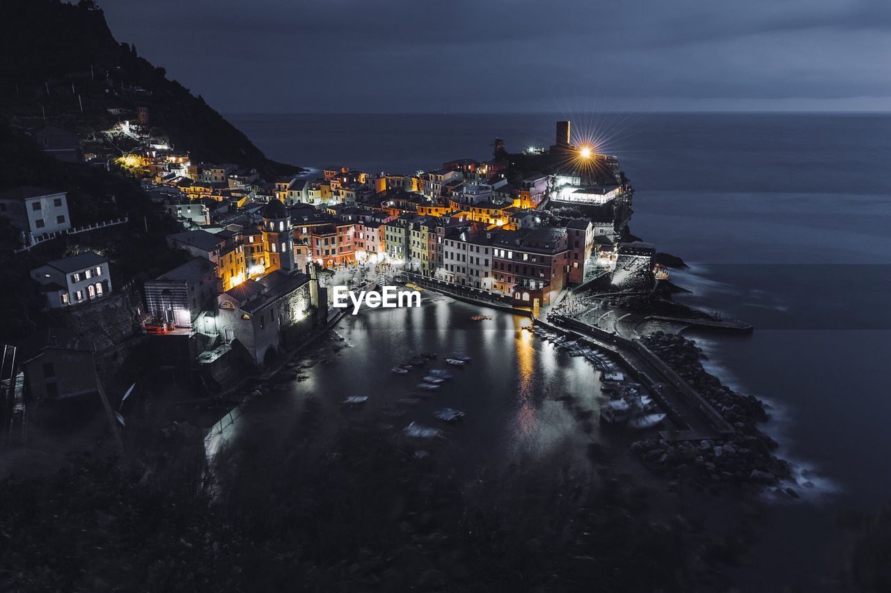 High angle view of buildings by sea in vernazza at night