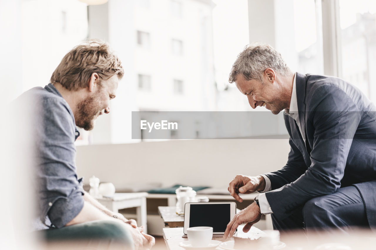 Businessman consulting customer in cafe