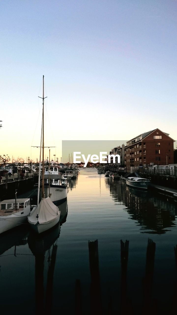 Boats moored on sea against sky