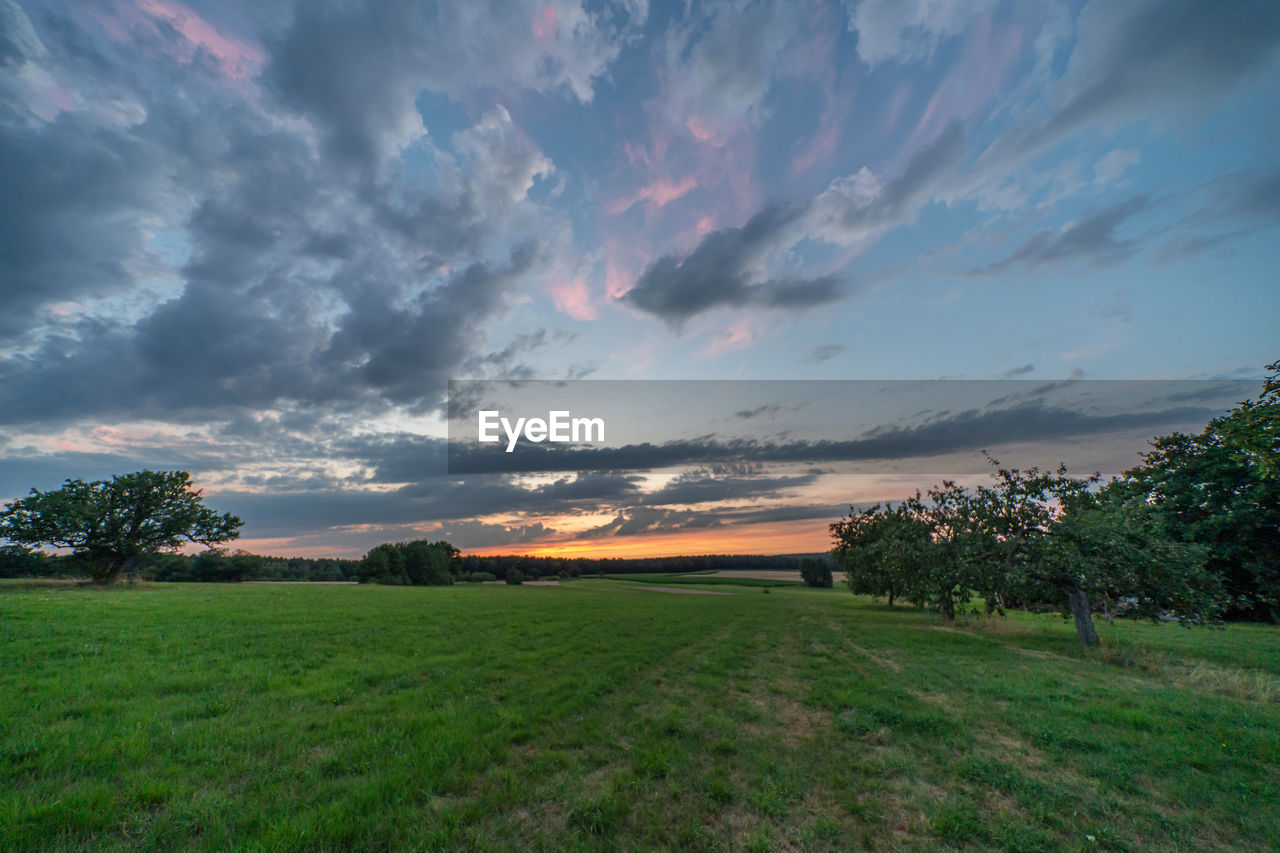 SCENIC VIEW OF LANDSCAPE AGAINST SKY DURING SUNSET