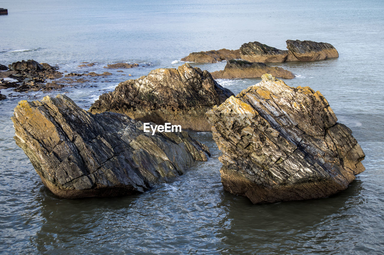 High angle view of rocks on sea shore