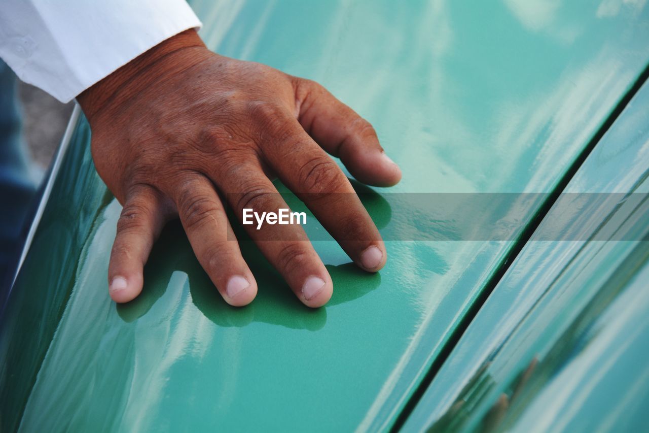 Cropped image of hand on vintage car