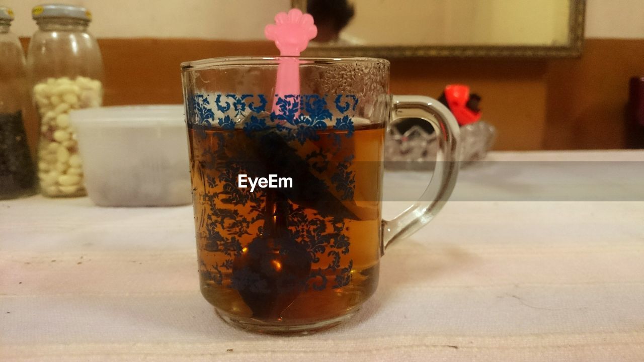 CLOSE-UP OF DRINK ON TABLE AT HOME