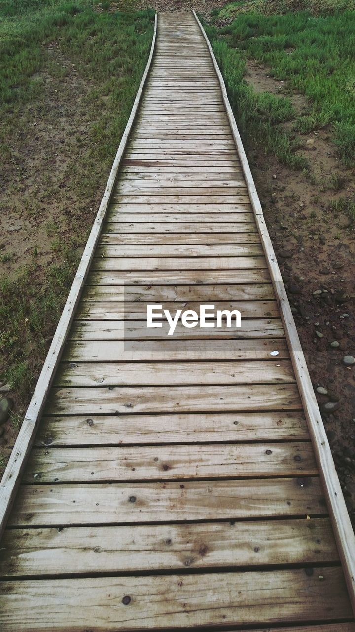 High angle view of empty boardwalk on field