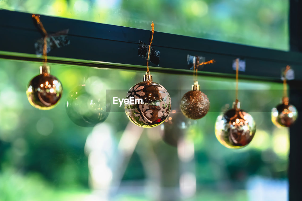 hanging, green, decoration, no people, focus on foreground, celebration, holiday, lighting equipment, event, illuminated, light, selective focus, close-up, outdoors, nature, tradition, christmas tree