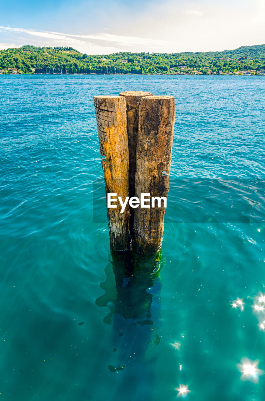 water, sea, no people, blue, nature, day, wood - material, tranquility, beauty in nature, outdoors, scenics - nature, tranquil scene, sky, waterfront, post, non-urban scene, turquoise colored, reflection, wooden post