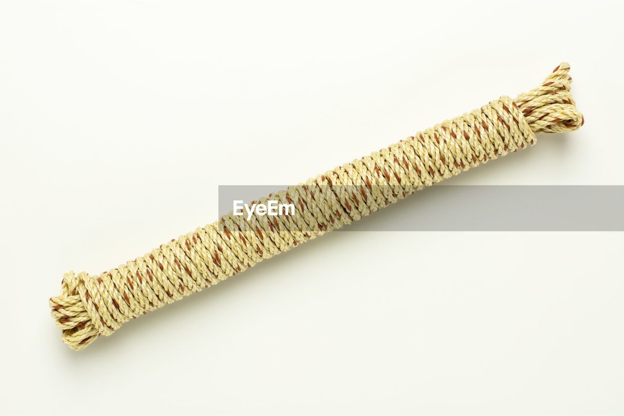 DIRECTLY ABOVE SHOT OF ROPE ON WHITE BACKGROUND