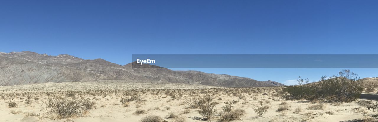 Scenic view of mountains against clear blue sky