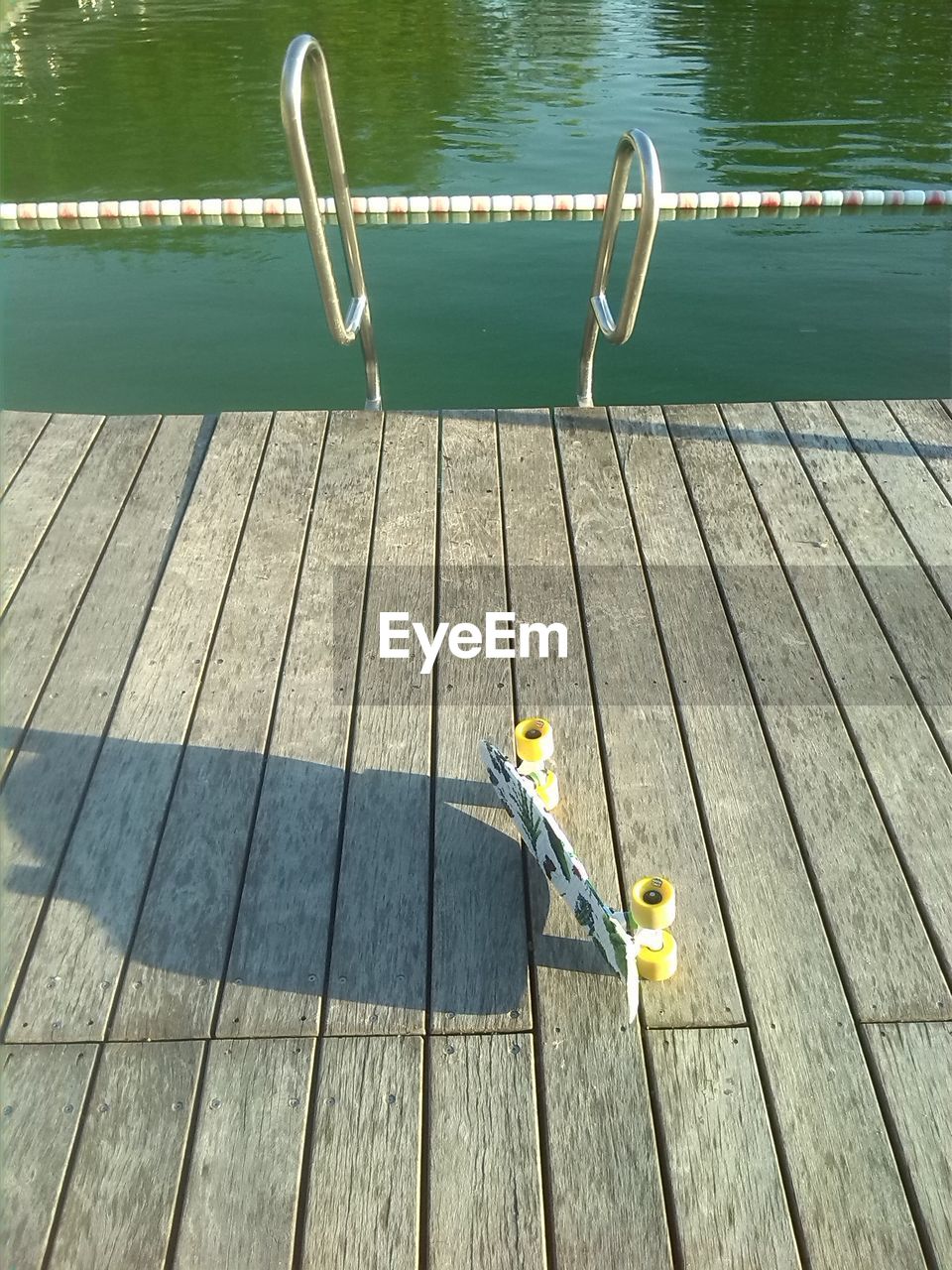 High angle view of skateboard on jetty