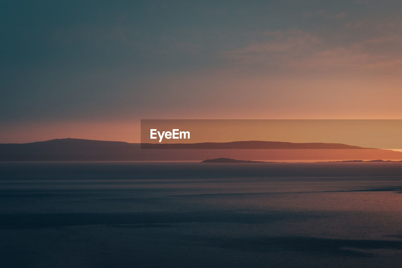 scenic view of sea against clear sky during sunset