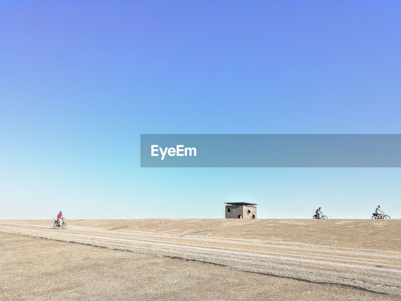 PEOPLE WALKING ON LAND AGAINST CLEAR SKY