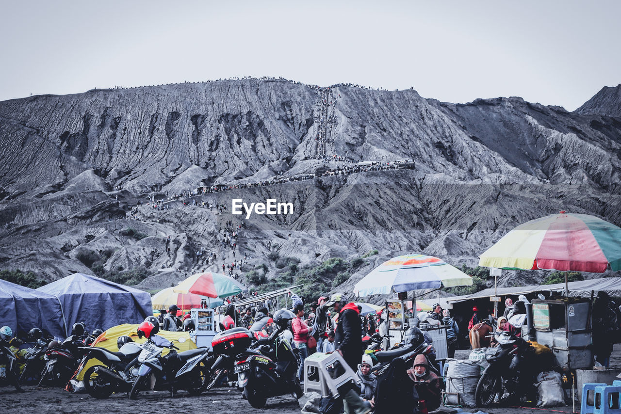 PEOPLE ON SNOWCAPPED MOUNTAINS AGAINST SKY