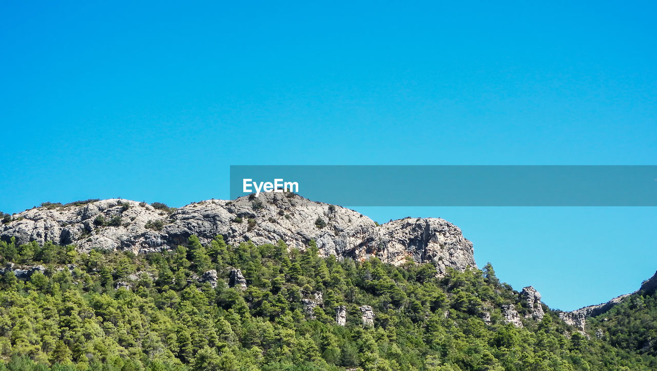 Low angle view of the mountain against clear blue sky