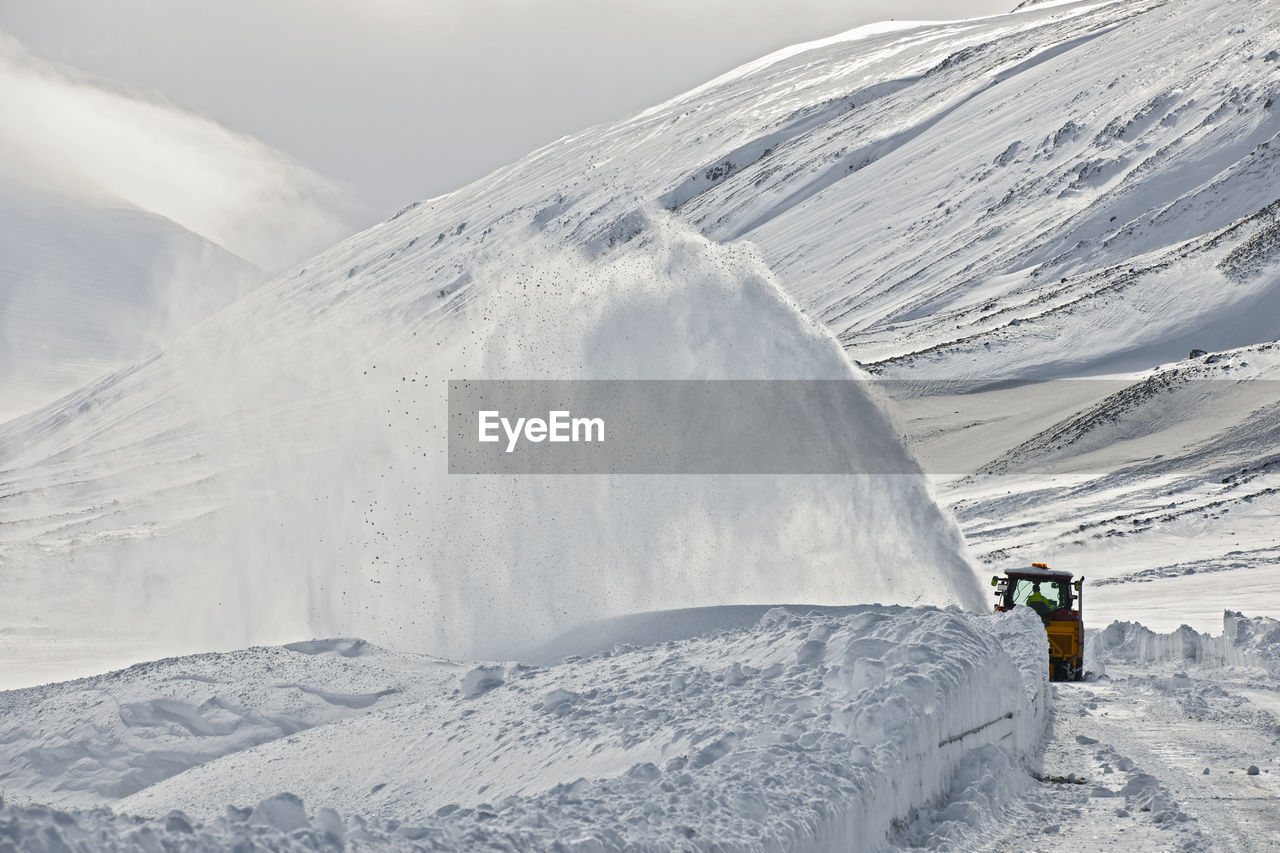 Snow plough clearing a mountain pass in north iceland