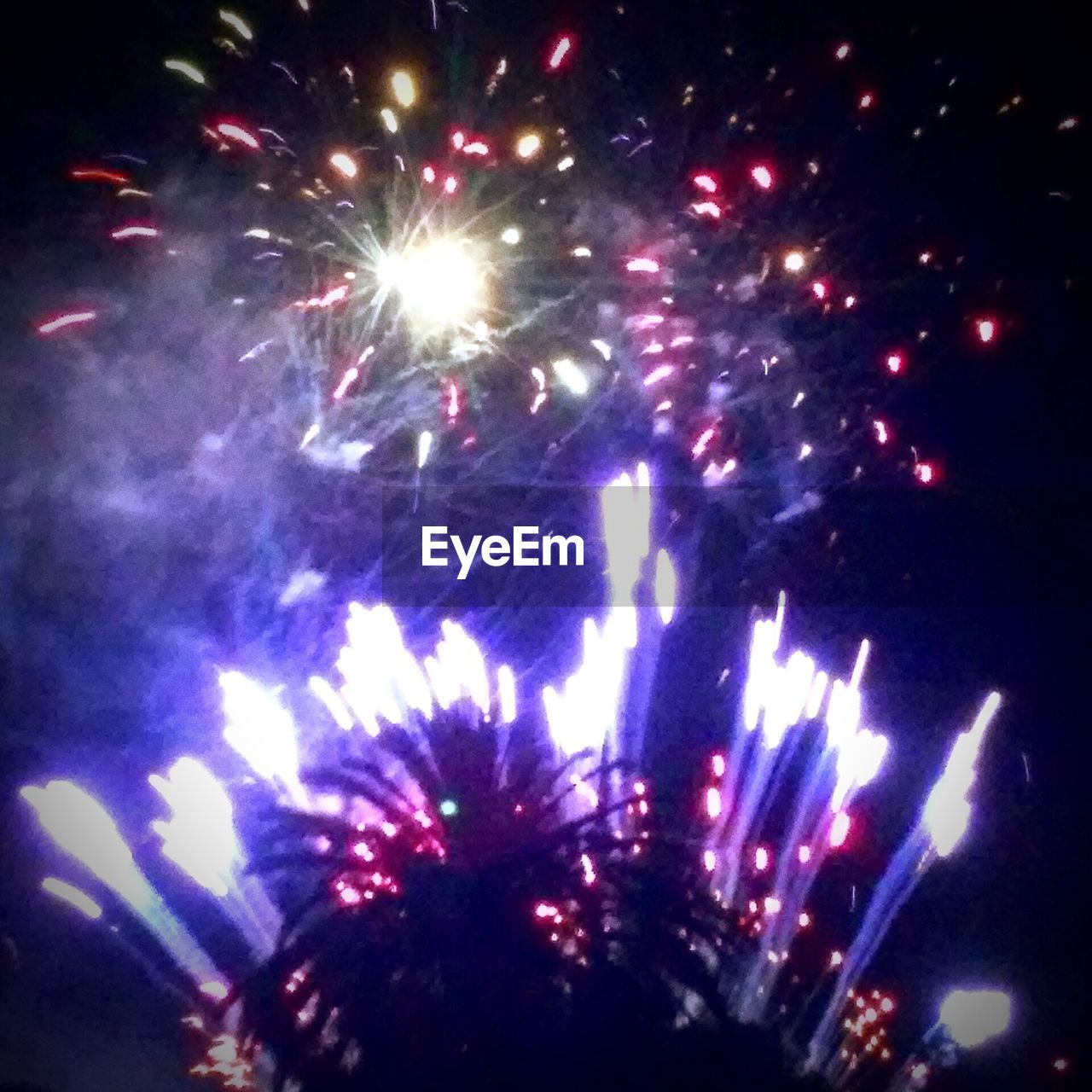 LOW ANGLE VIEW OF FIREWORKS EXPLODING IN SKY