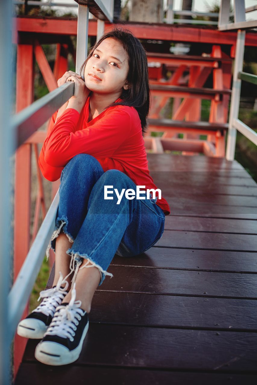 Portrait of girl sitting outdoors