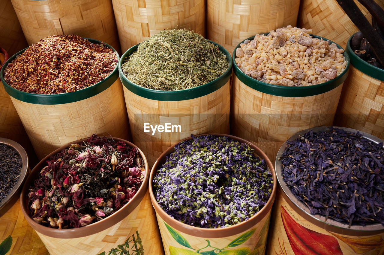 Baskets dried spices, tea and incense at bazaar market in dubai filling the frame