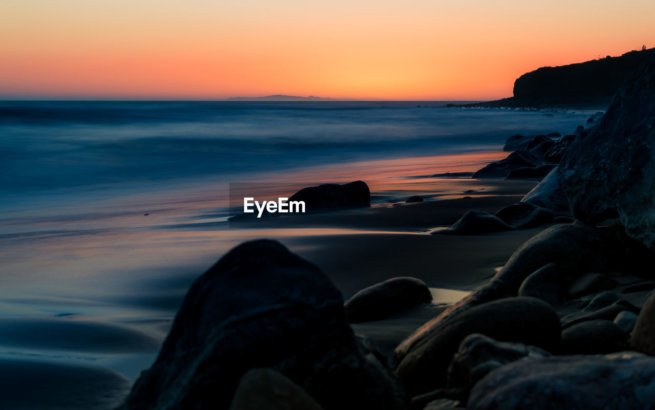 Scenic view of sea against sky during sunset