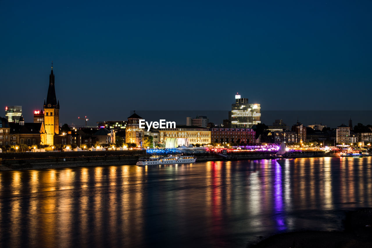 Illuminated city at waterfront