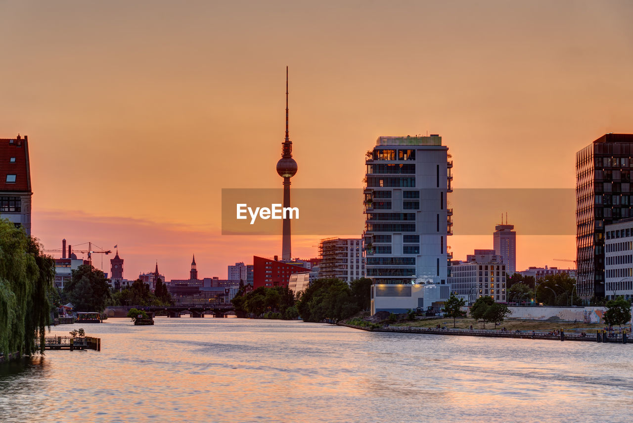 Beautiful orange sky at sunset over berlin with the famous television tower