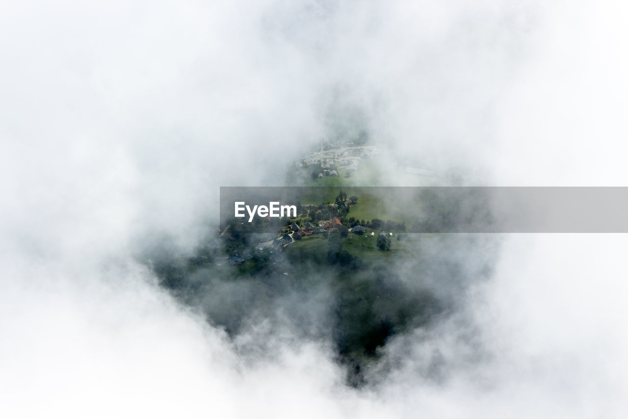 High angle view of village seen through cloud