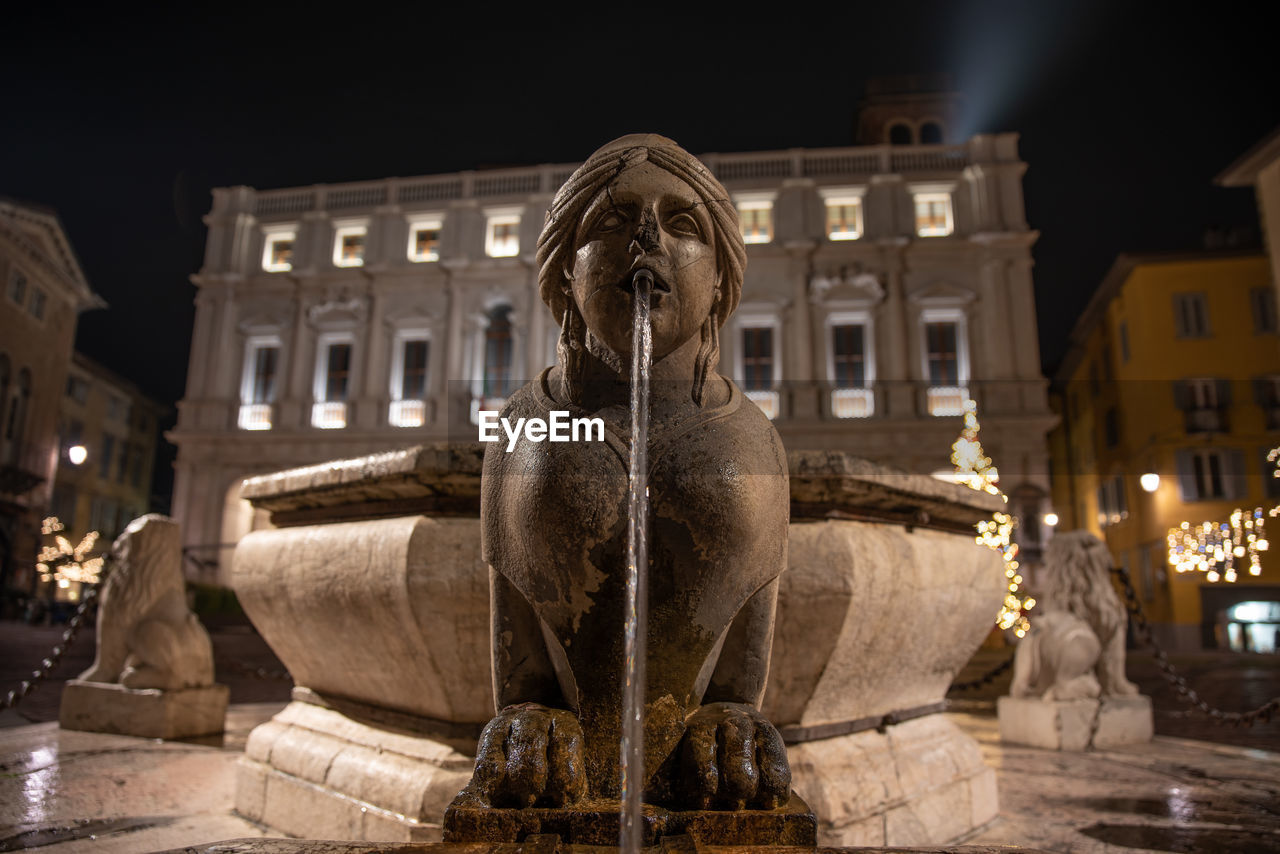 Statue of illuminated building at night, bergamo cityscape, fontana contarini in città alta