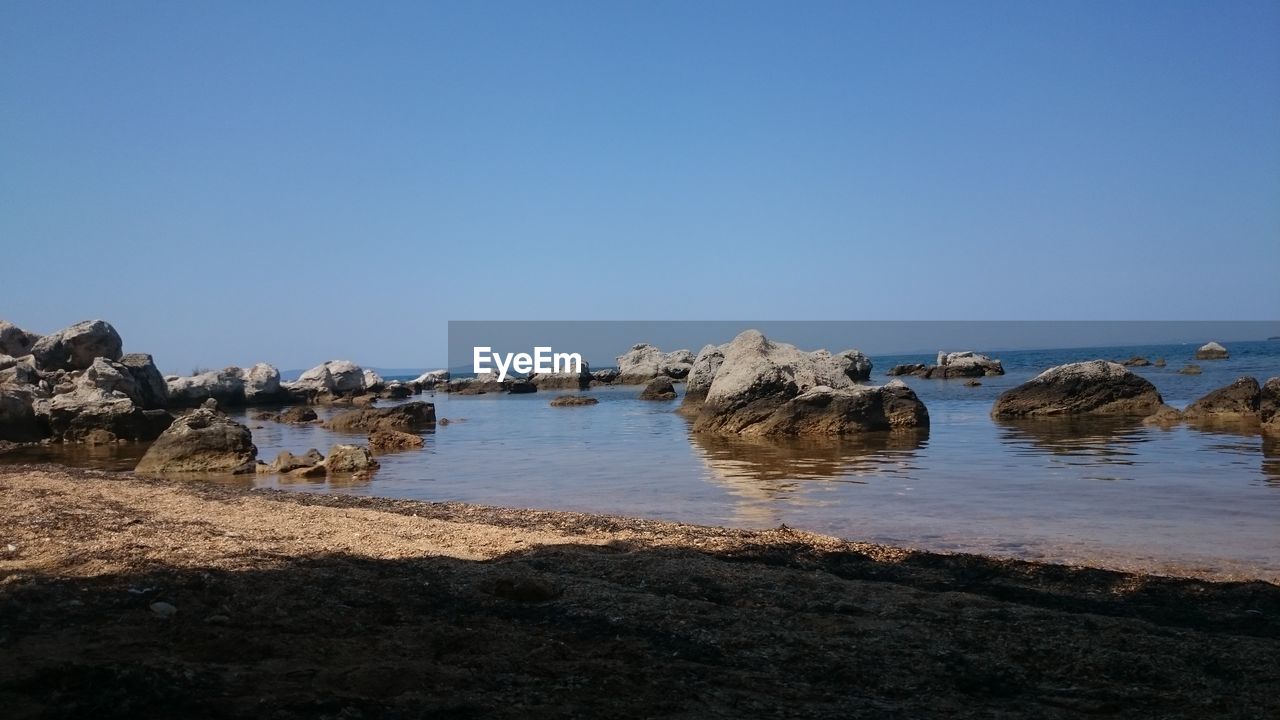 Scenic view of sea against clear blue sky