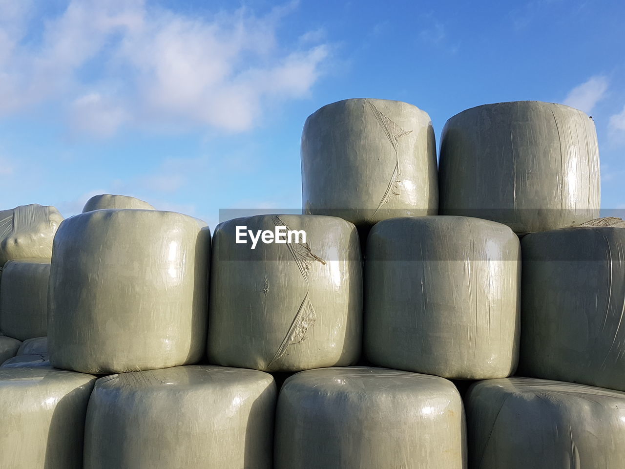 LOW ANGLE VIEW OF STACK OF FIREWOOD AGAINST SKY