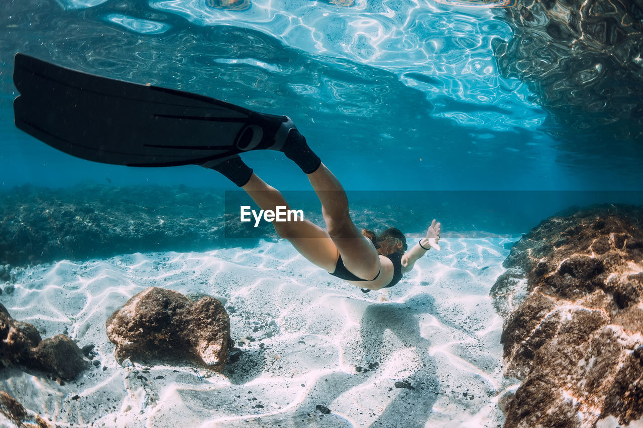 high angle view of man swimming in sea