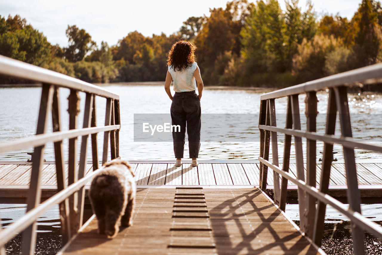 rear view of woman standing by railing