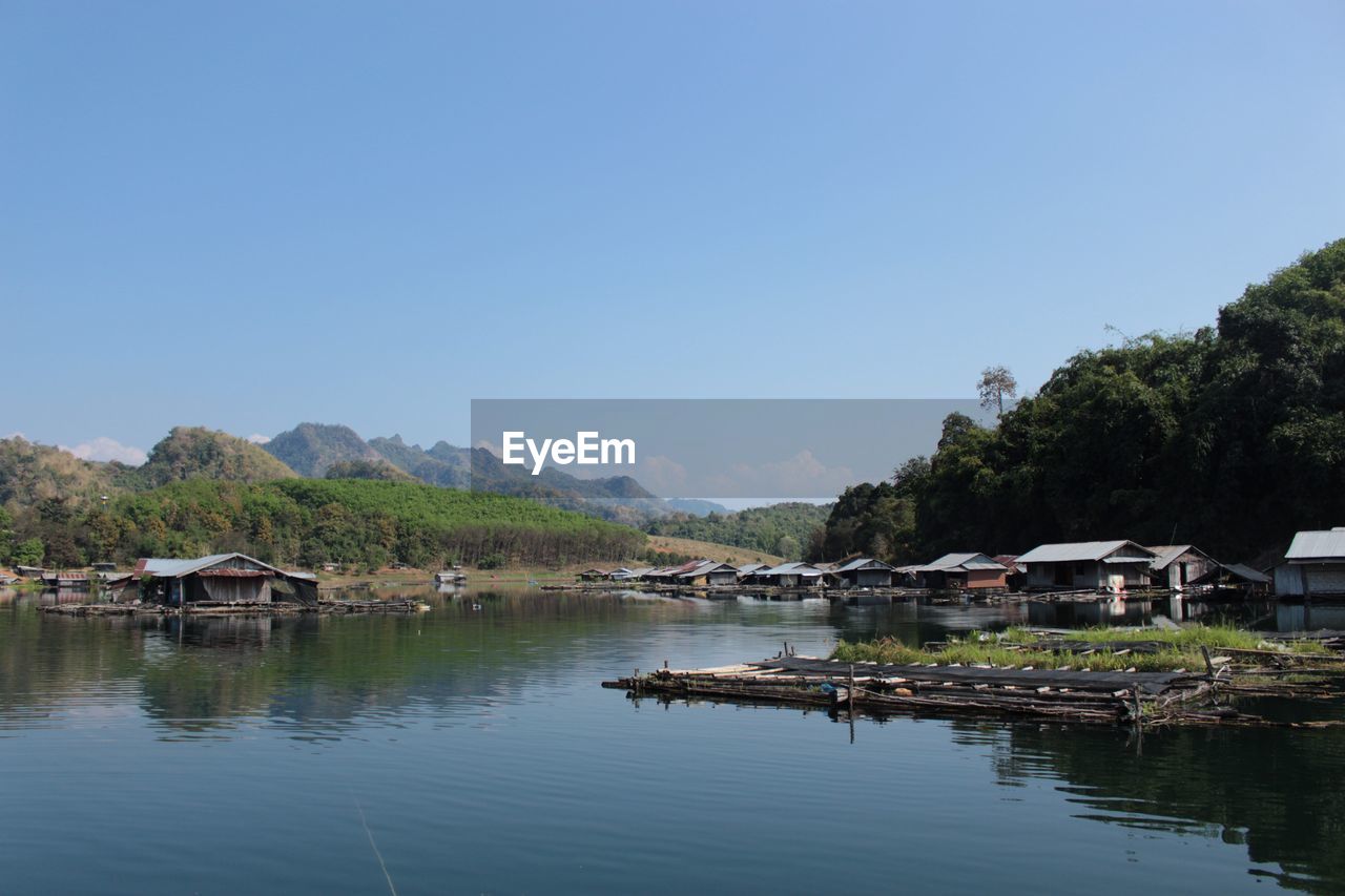 Scenic view of lake by building against sky