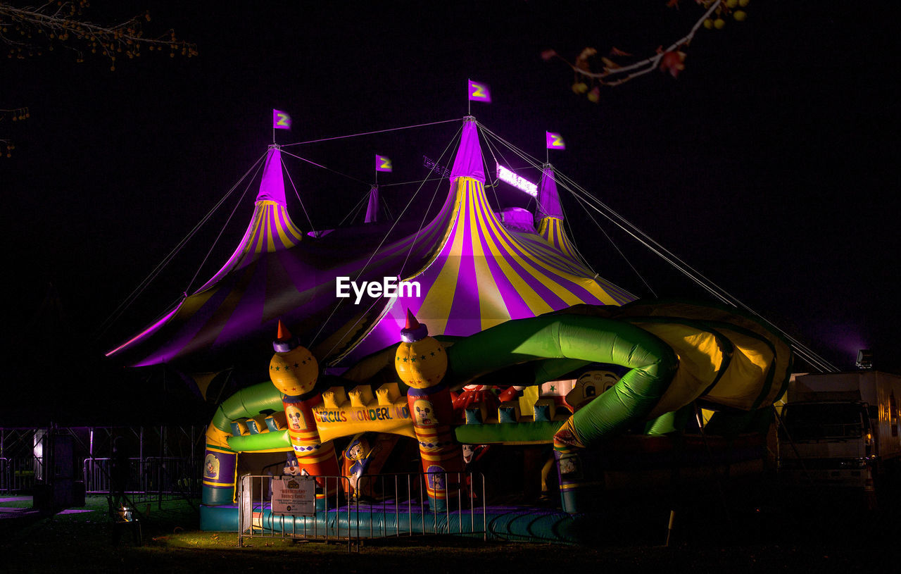 ILLUMINATED CAROUSEL AT AMUSEMENT PARK