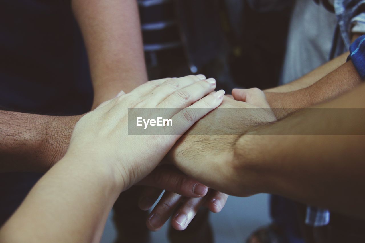 CLOSE-UP OF HANDS TOUCHING WOMAN