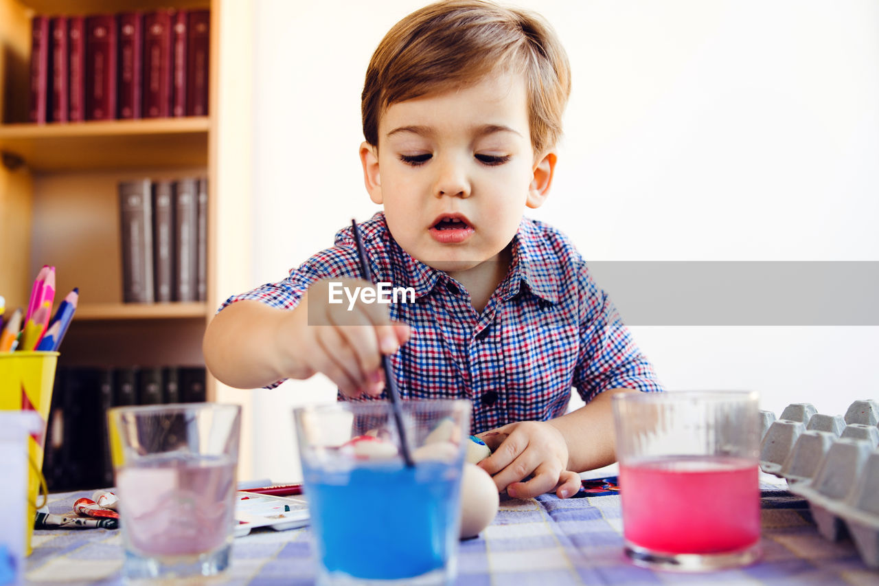 Boy painting egg