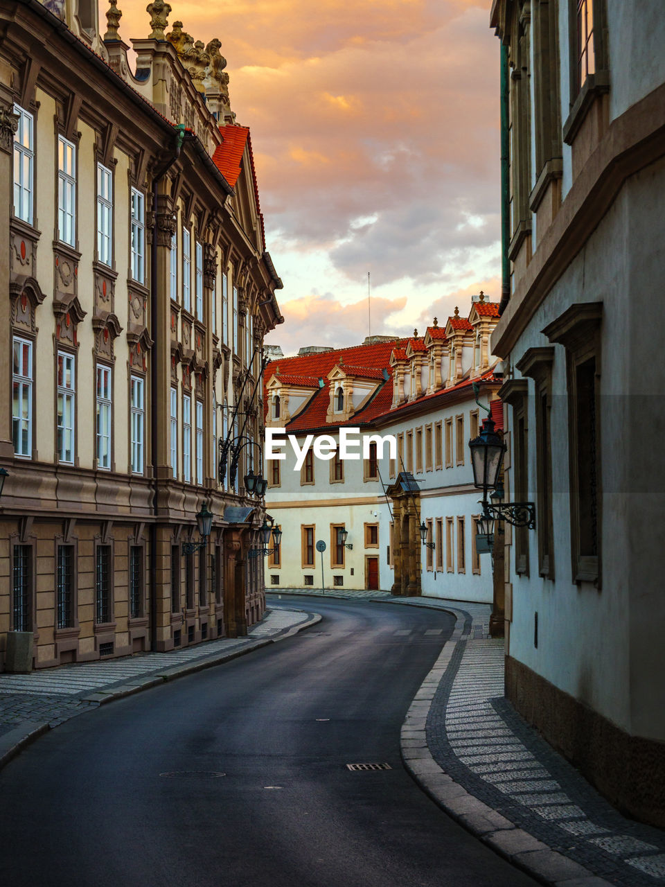 STREET AMIDST BUILDINGS AGAINST SKY