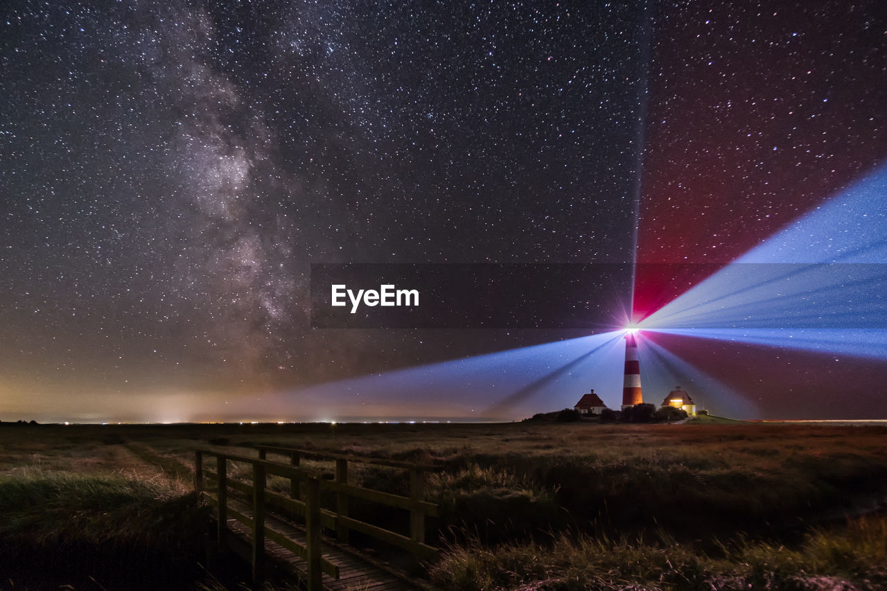 Scenic view of field against sky at night