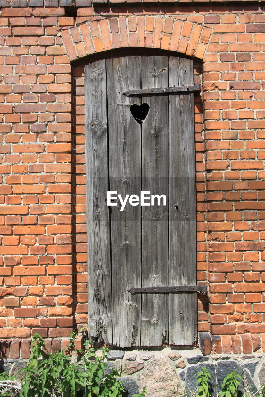 Closed door of brick wall