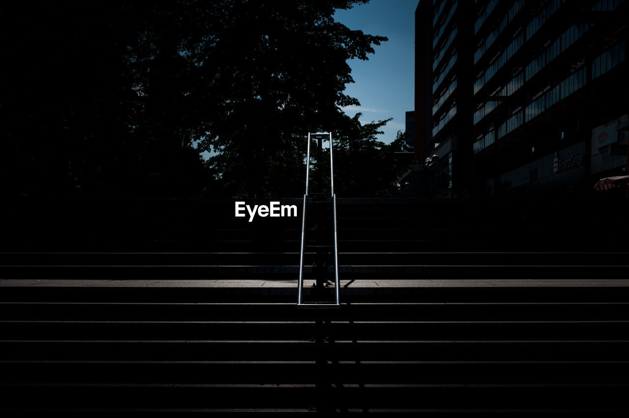 Silhouette of staircase against building at night