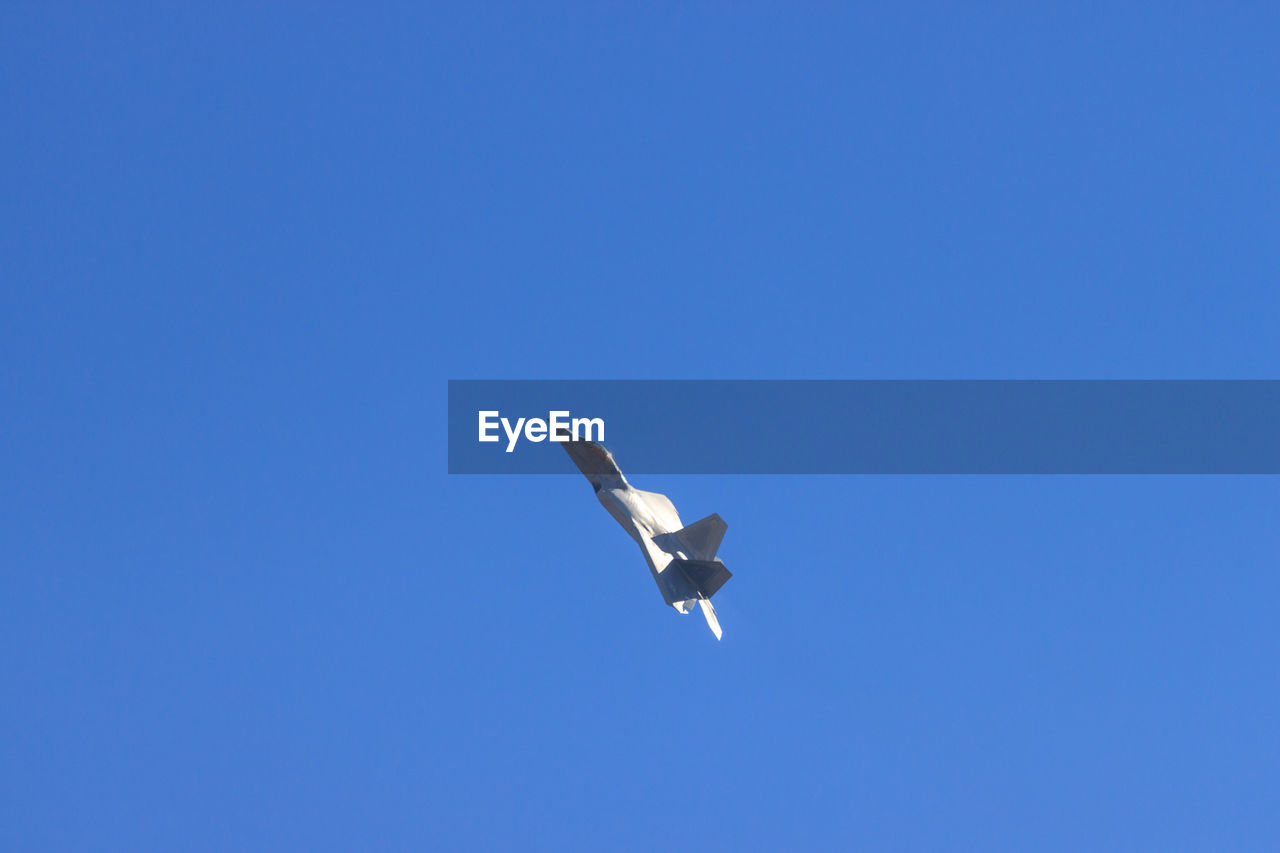 LOW ANGLE VIEW OF AIRPLANE FLYING IN SKY