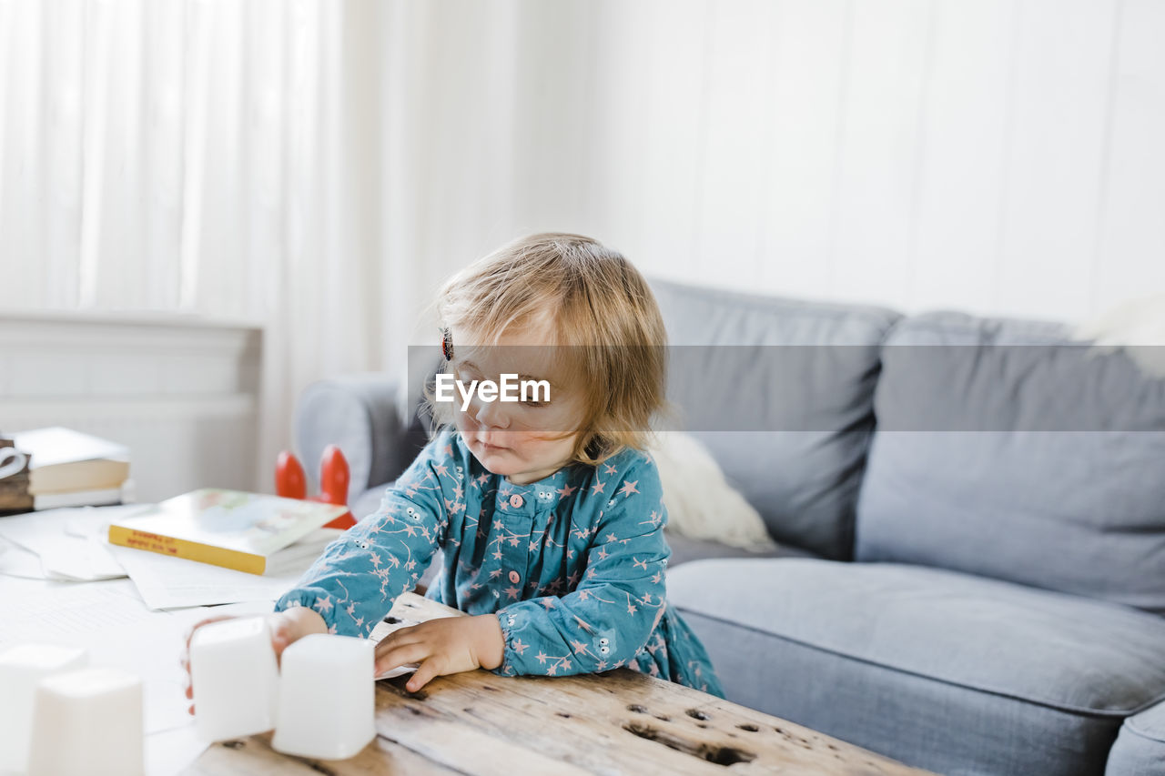 Cute girl playing with toys at home