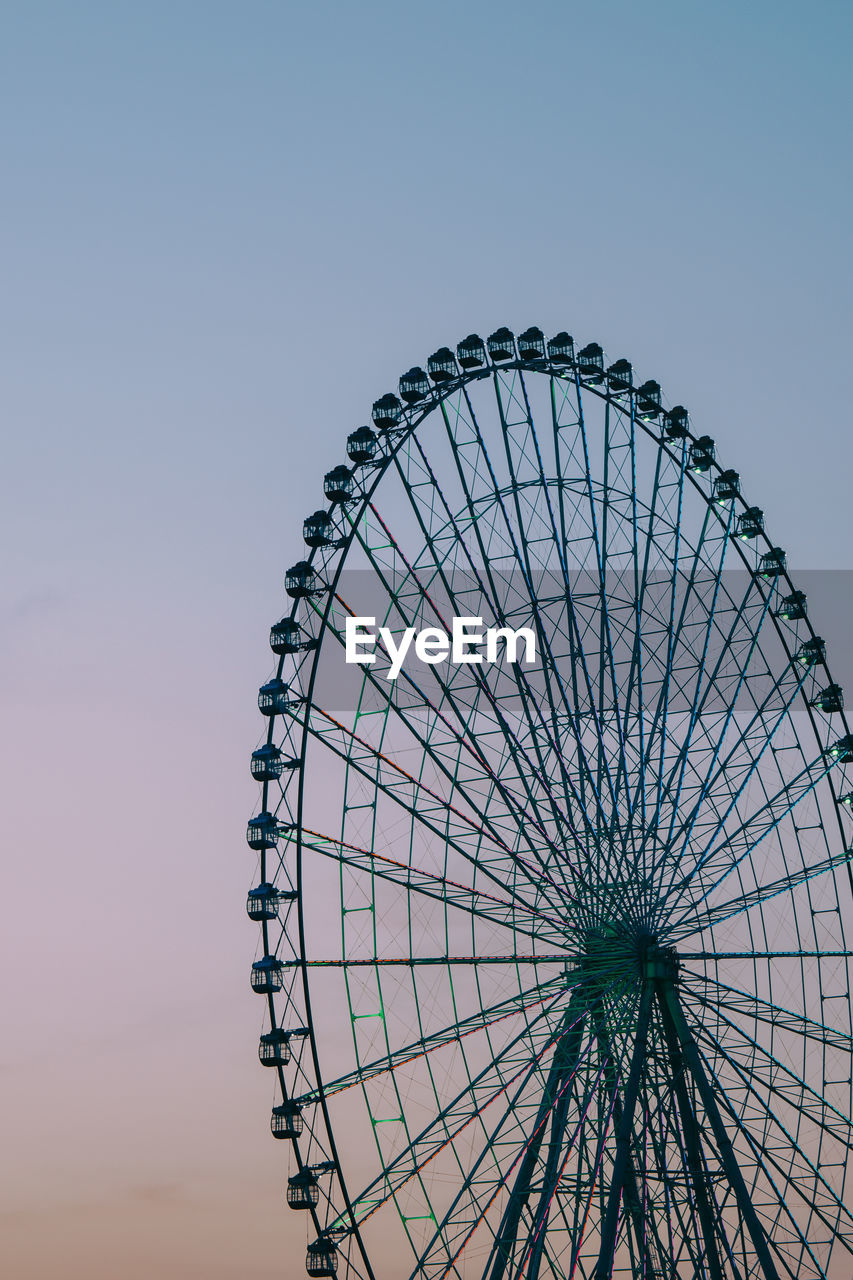 ferris wheel, amusement park ride, amusement park, sky, arts culture and entertainment, recreation, nature, no people, clear sky, carnival, geometric shape, circle, low angle view, traveling carnival, outdoors, shape, blue, architecture, travel destinations, fun, spinning, wheel, built structure