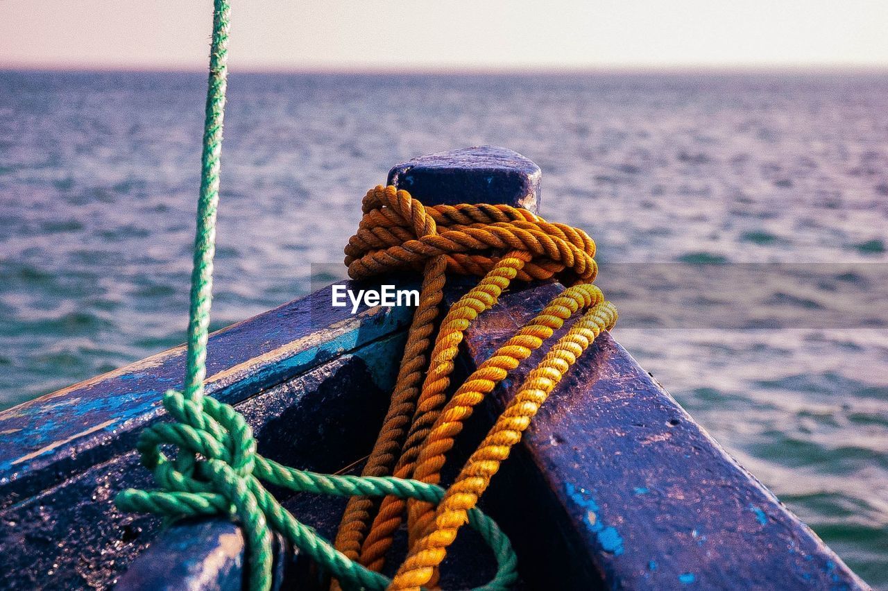 Close-up of rope tied on boat in sea